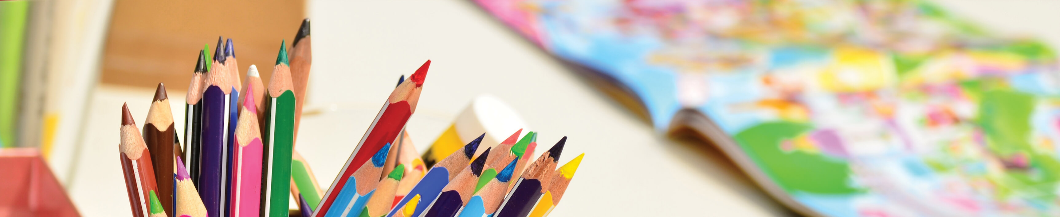 Children raising their hands while sitting at desks